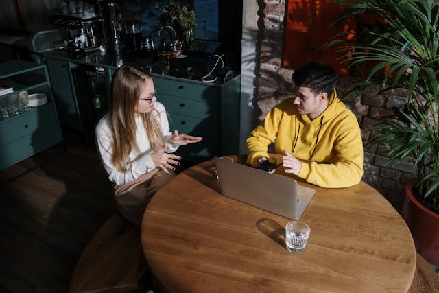 two people at a table having a conversation