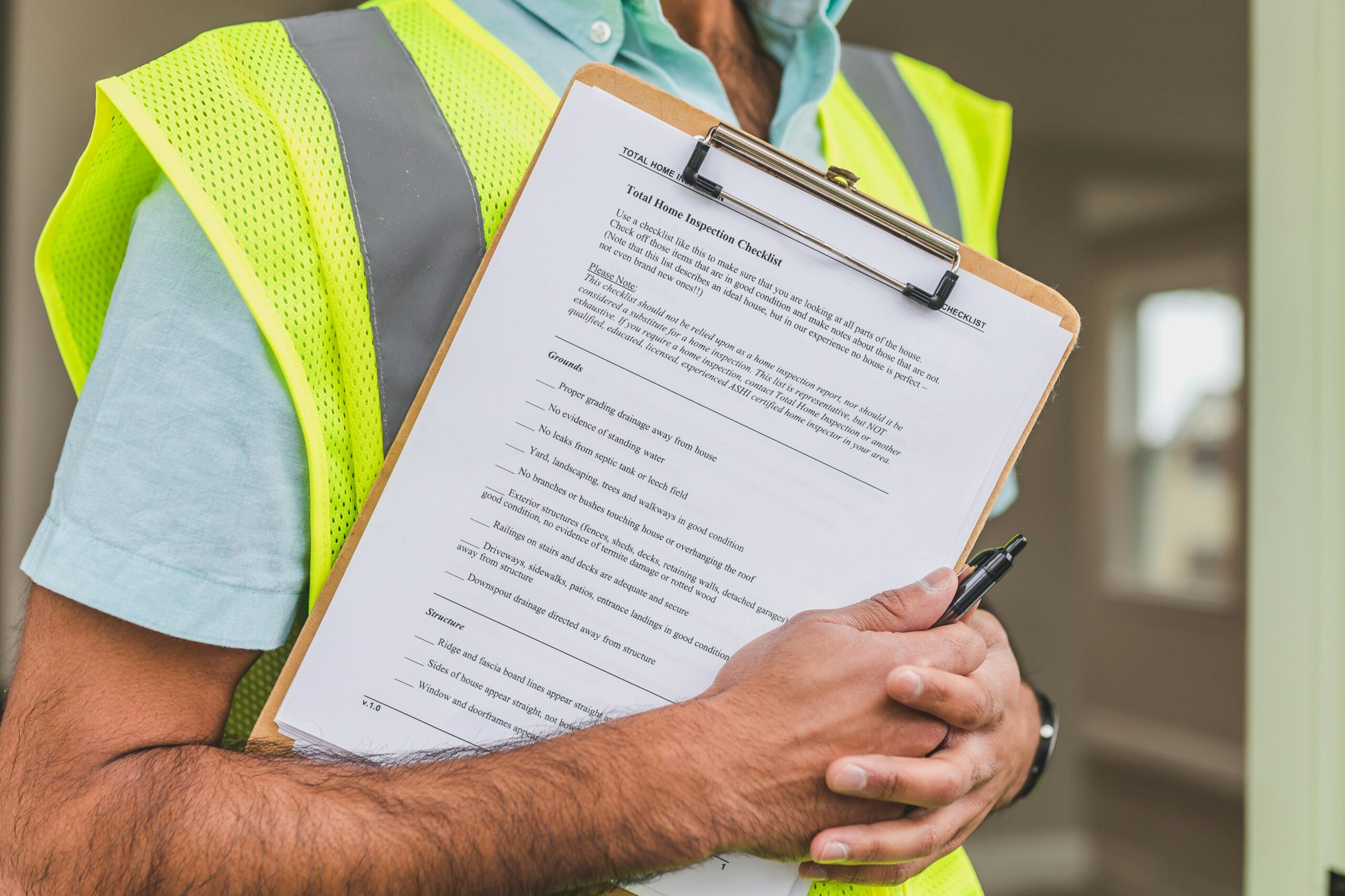 person-holding-clipboard-in-yellow-vest
