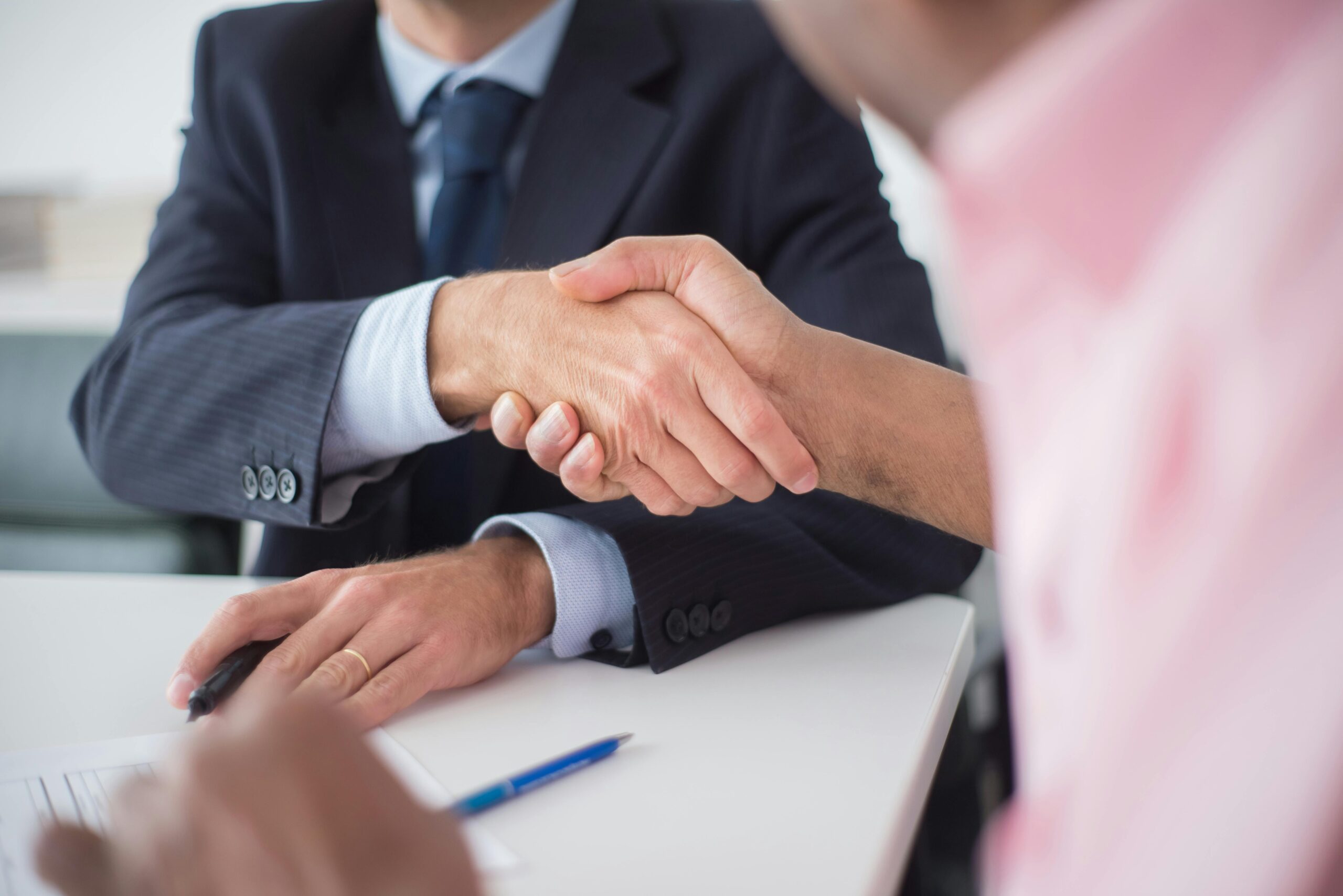 people-shaking-hands-with-paperwork