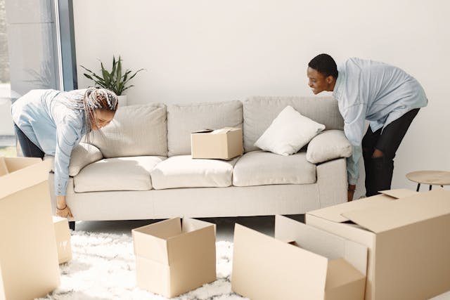 people-smiling-moving-couch