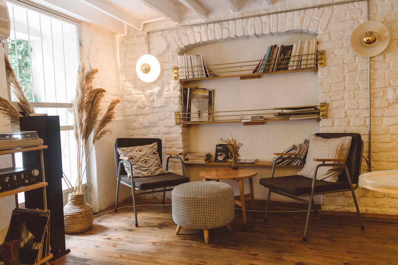 living room with white stone walls and bookshelf